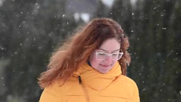 Mujer caucásica pelirroja se regocija en la primera nieve. — Vídeos de Stock