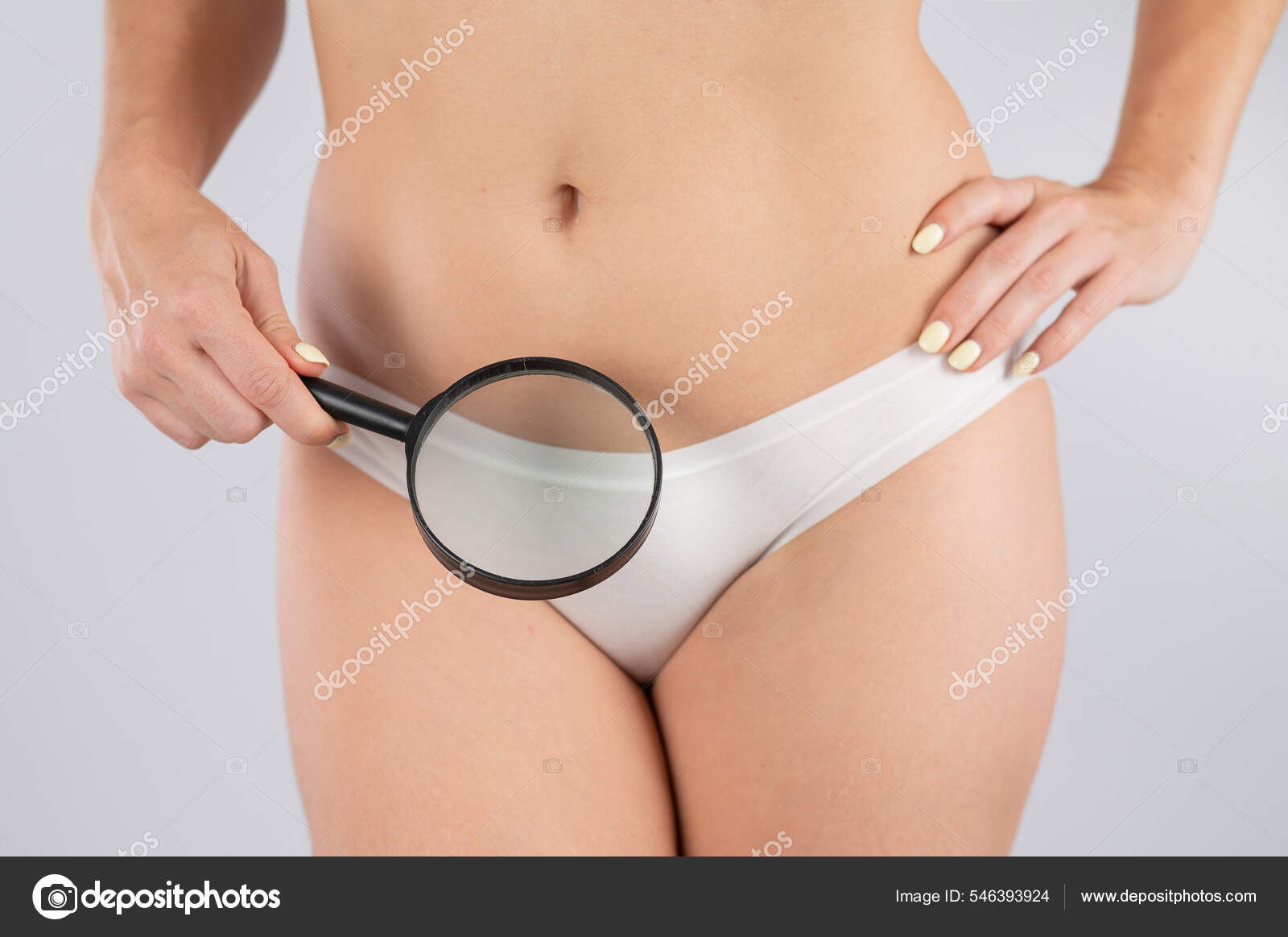 A woman in white shorts holds a magnifying glass on a white