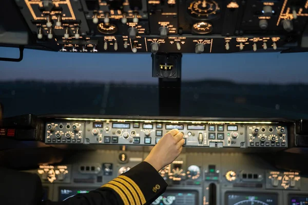 Close-up of a pilots hand on an airplane control panel. — Stock Photo, Image