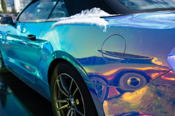 The car is painted in chameleon paint with a greenish-yellow tint. — Stock Photo, Image