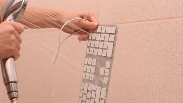 Close-up woman washes white computer keyboard under running water. — Stock Video