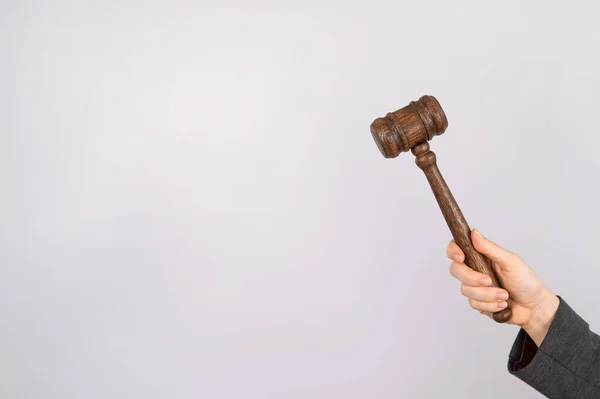 Woman holding judges gavel on white background. — Stock Photo, Image