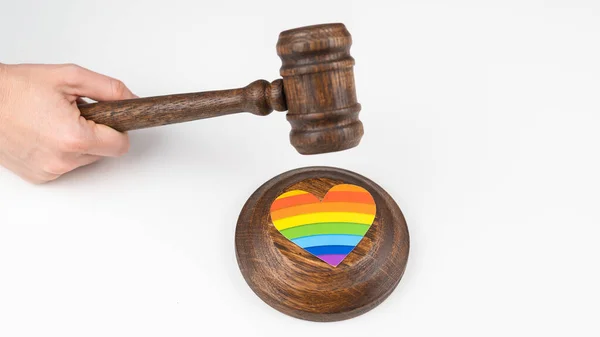 The judge hits a heart with a rainbow flag with a gavel. — Stock Photo, Image