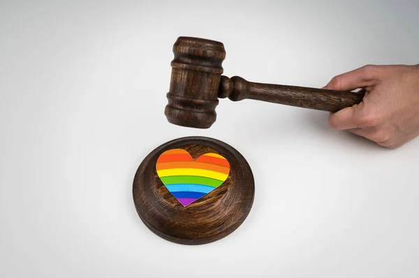 The judge hits a heart with a rainbow flag with a gavel. — Stock Photo, Image