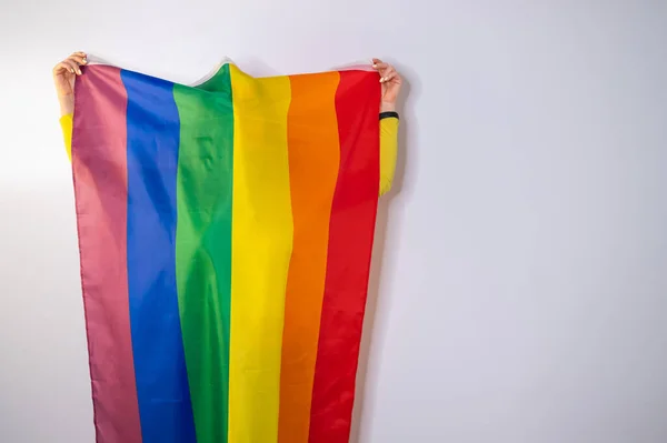 Caucasian woman holding lgbt flag covering herself. — Stock Photo, Image