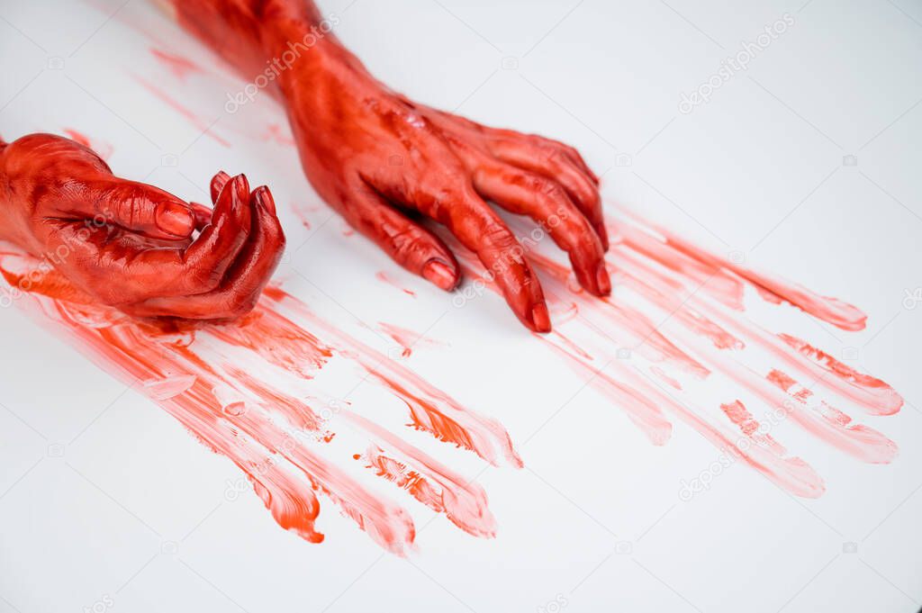 Female hands in blood on a white background. 