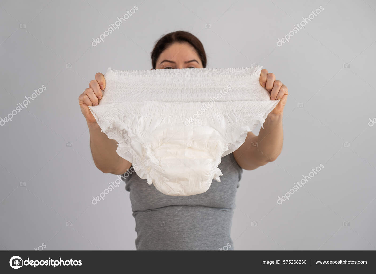 Woman wearing adult diaper against white background. 16251982