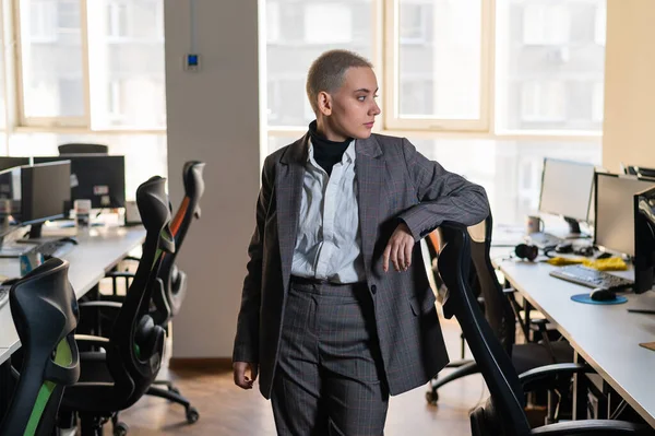 Business woman with short haircut in empty office