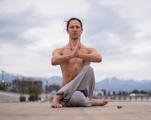Caucasian man practices martial arts outdoors. balance and meditation