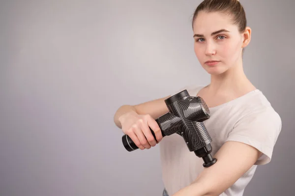 Blanke Vrouw Gebruikt Een Massagepistool Voor Pijn Spieren Van Arm — Stockfoto