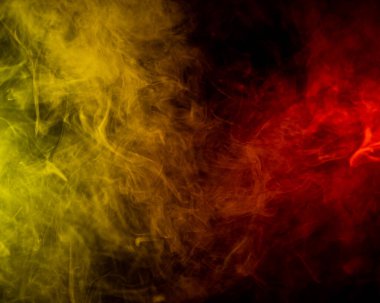 Kırmızı-sarı duman siyah arkaplanda yayılır