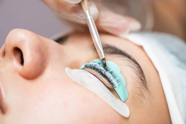 Close-up portrait of a woman on eyelash lamination procedure