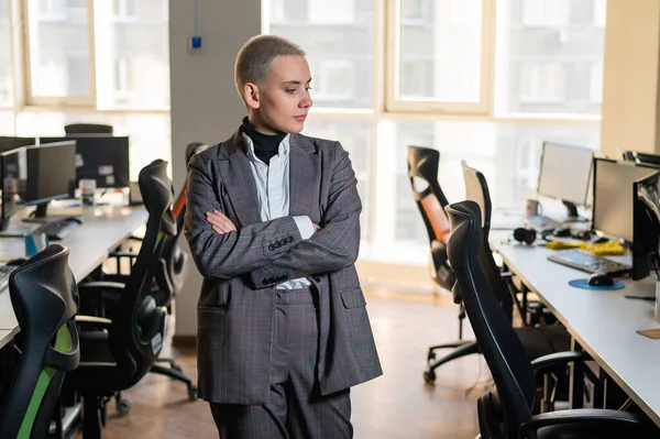 Business woman with short haircut in empty office