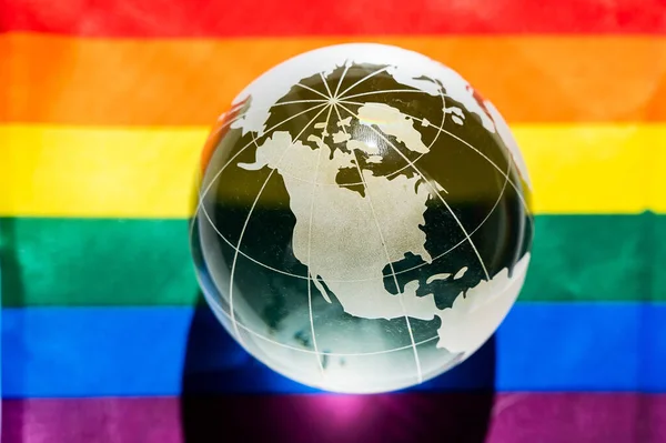 Crystal globe on a rainbow flag. LGBT community