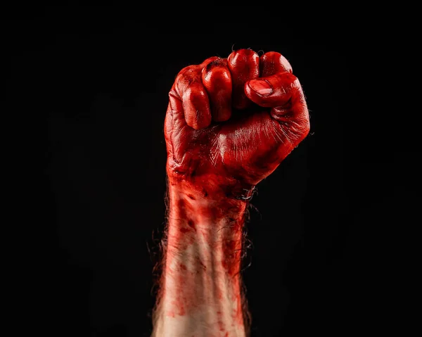 Bloody male fist on a black background