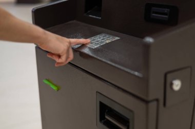 Yüzsüz kadın ATM 'de banka kartı şifresini çeviriyor.