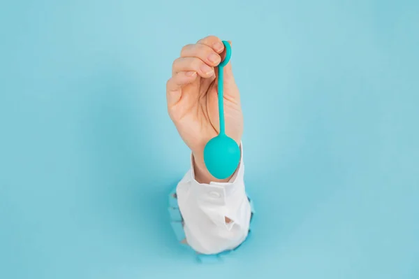 Womans Hand Sticks Out Hole Blue Background Holds Vaginal Egg — Stock Photo, Image