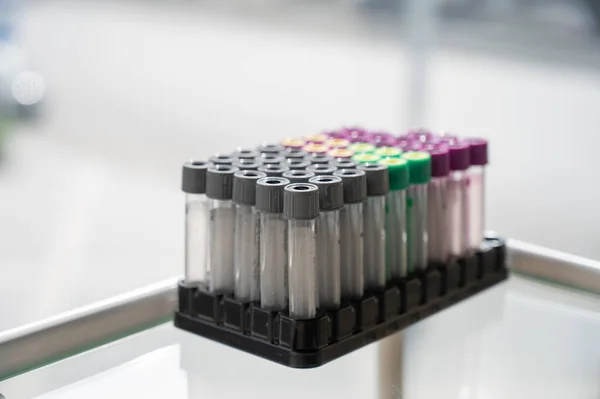 A set of test tubes with lids on a stand in the cosmetologists office