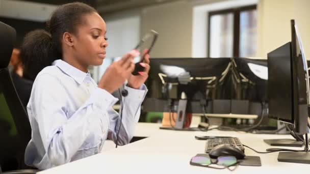 African Woman Call Center Employee Puts Headset Starts Working — Stock Video