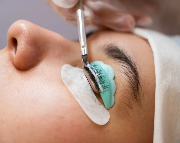 Close-up portrait of a woman on eyelash lamination procedure