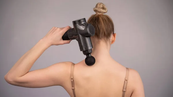 Caucasian Woman Giving Herself Back Massage Gun — Stock Photo, Image