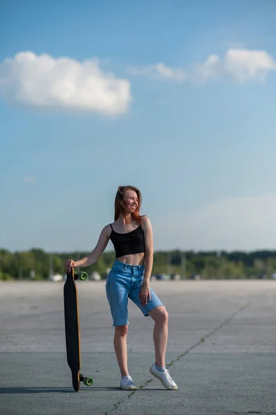 Young Caucasian Woman Holding Long Board Outdoors — Stock Photo, Image