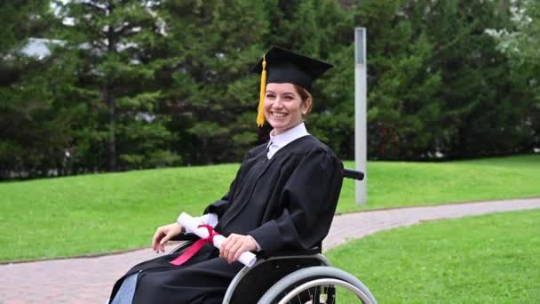 Caucasian Woman Wheelchair Graduate Costume Rejoices Receiving Diploma — Stock Video