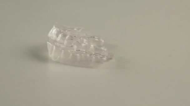 Transparent Plastic Aligner Spinning White Background — Stock Video