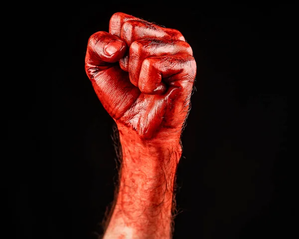 Bloody male fist on a black background