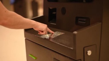 Yüzsüz kadın ATM 'de banka kartı şifresini çeviriyor.