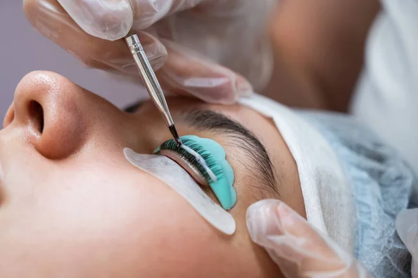 Close-up portrait of a woman on eyelash lamination procedure