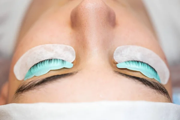 Profile of a woman in a beauty salon on the procedure of eyelash lamination