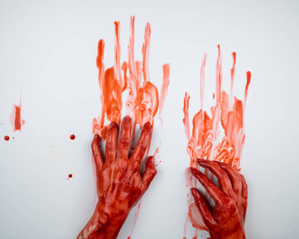 Женские руки в крови на белом фоне