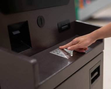 Yüzsüz kadın ATM 'de banka kartı şifresini çeviriyor.