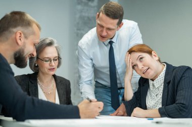 Patron ofis konferans odasında üç çalışana talimat verir. Beyin fırtınası yapan mühendisler ve mimarlar.