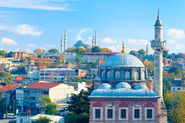 In the heart of Istanbul: beautiful view of Sebsefa Hatun mosque and Ottoman imperial mosque - Suleymaniye in the background. Fatih, Istanbul, Turkey