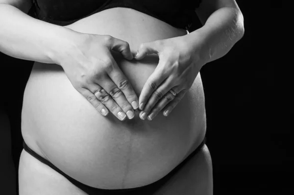 Heart shape on baby belly. — Stock Photo, Image