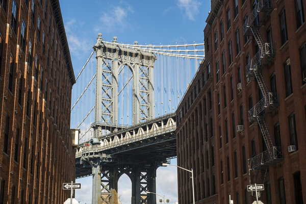 NEW YORK, US - NOVEMBER 24: Brooklyn Bridge framed between brick buildings. November 24, 2013 in New York.
