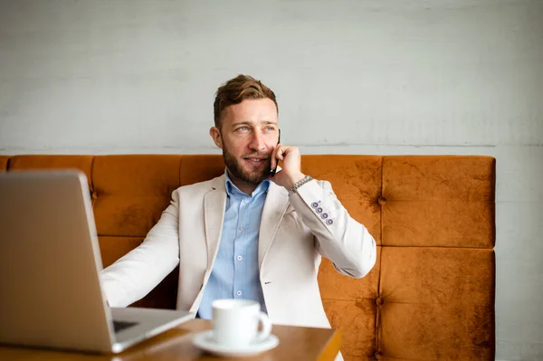 Hombre Negocios Sonriente Está Sentado Café Hablando Por Teléfono Una — Foto de Stock