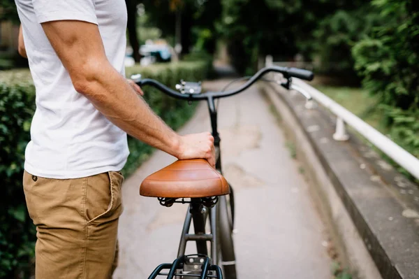 the guy walks next to the bike, up close.