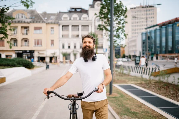 Man with beard.Cycling day in urban area.