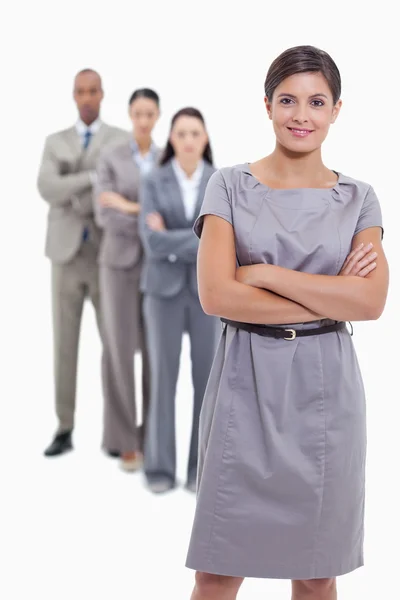 Woman smiling with her business team crossing their arms — Stock Photo, Image
