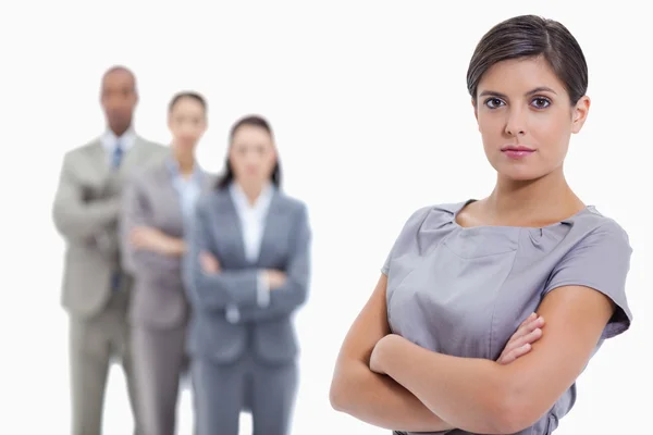 Close-up of a serious businesswoman and a team crossing their ar — Stock Photo, Image
