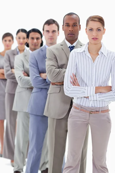 Serious colleagues dressed in suits crossing their arms in a sin — Stock Photo, Image