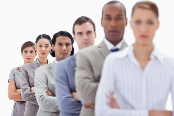 Close-up of serious workmates dressed in suits crossing their ar — Stock Photo, Image