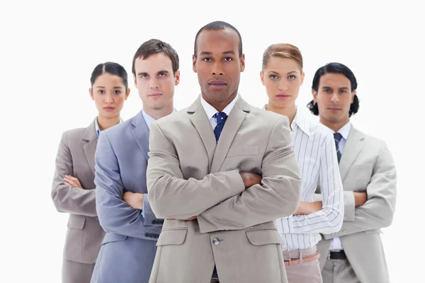 Close-up of a serious business team crossing their arms — Stock Photo, Image