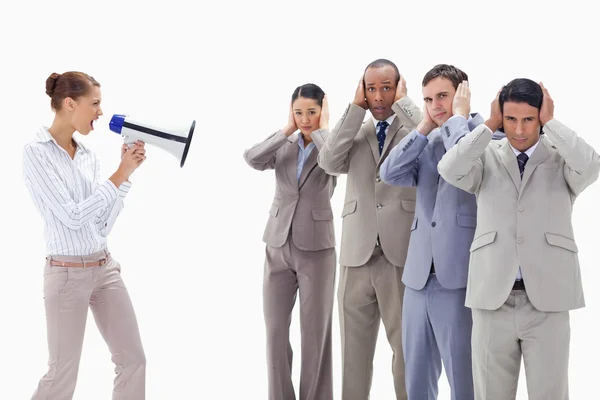 Woman yelling through a megaphone at business covering th — Stock Photo, Image