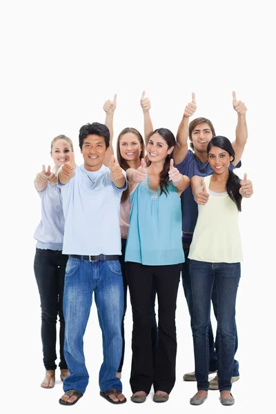 Smiling together and approving with the thumbs-up — Stock Photo, Image