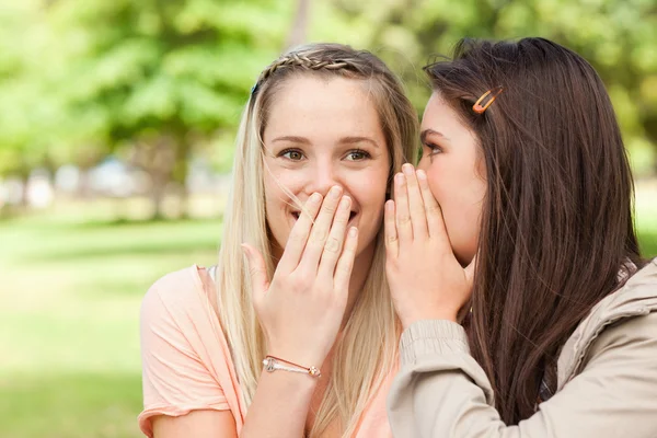 Close-up of teenagers sharing a secret — Stock Photo, Image