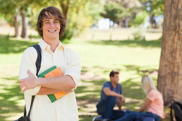 Young man posing with textbook — Stock Photo, Image